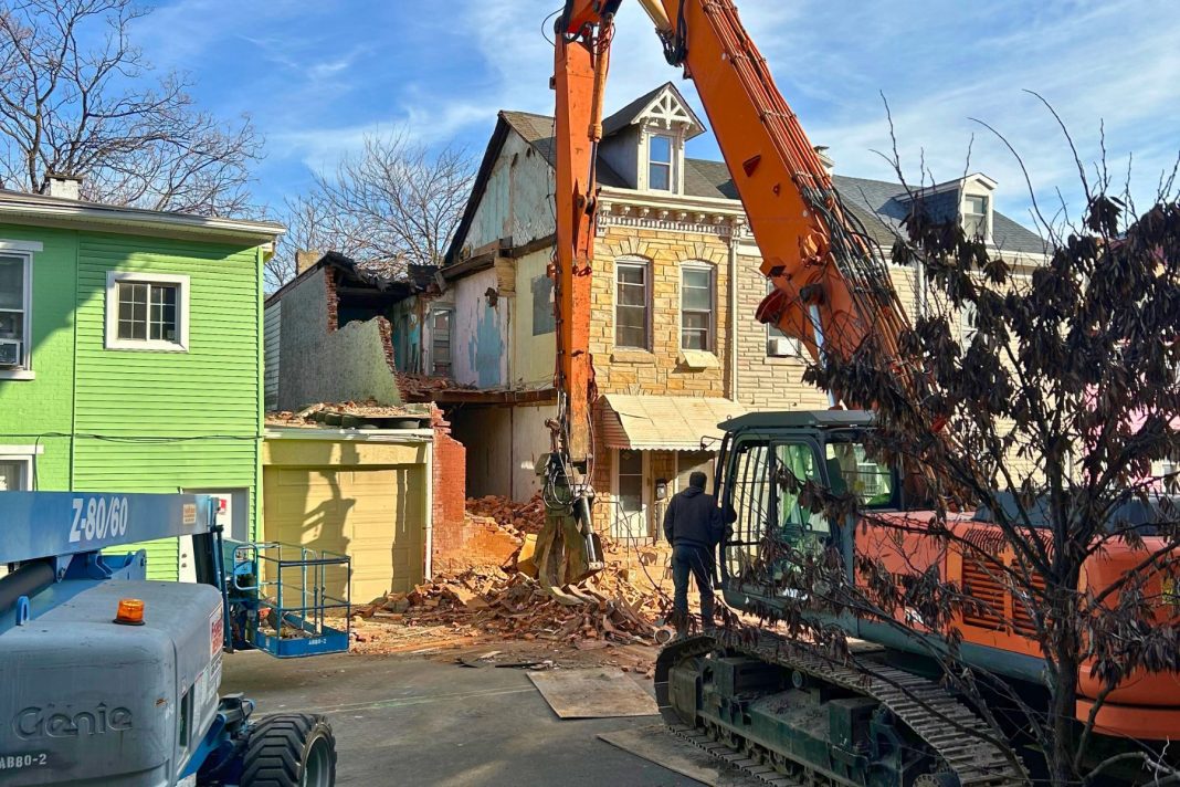 An emergency crew works to dismantle a Poplar Street home in Reading, following a partial building collapse.