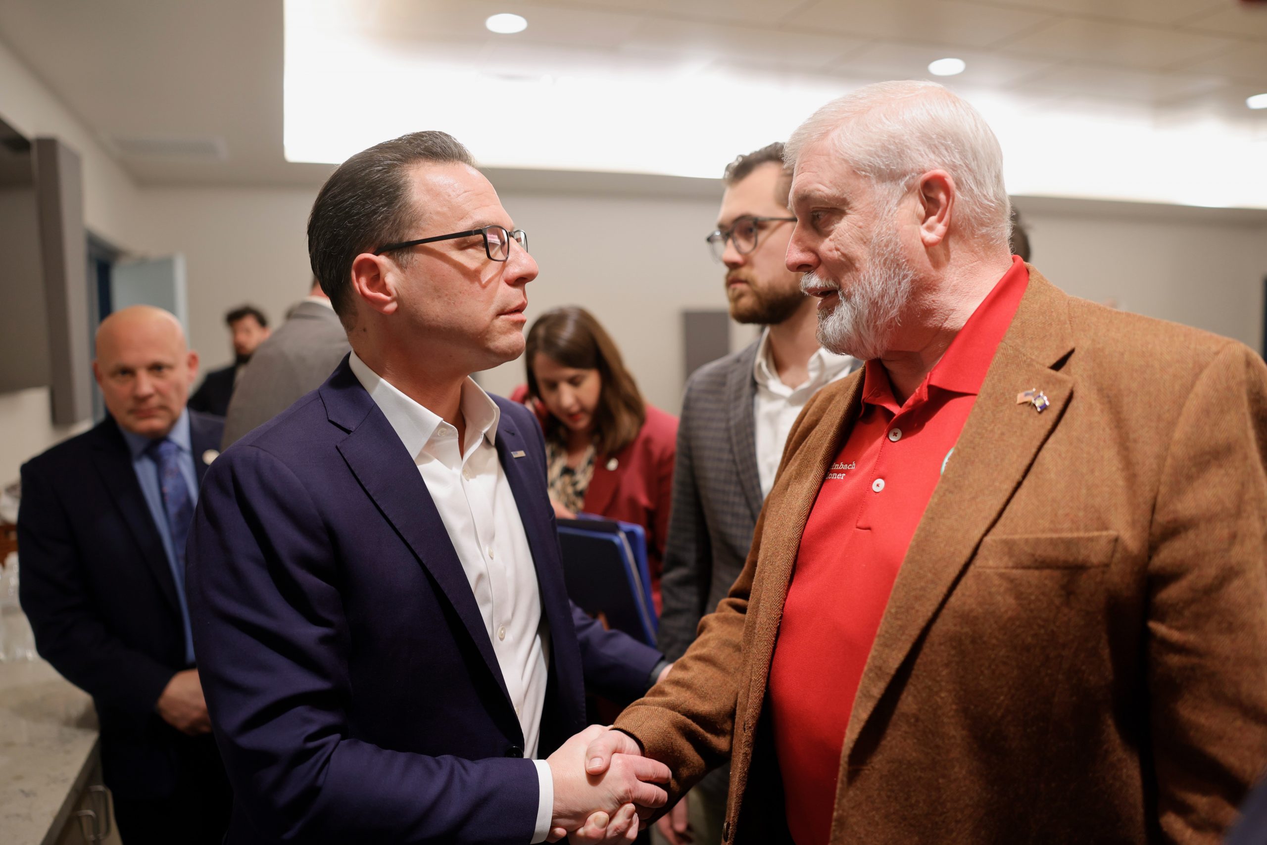 Gov. Josh Shapiro shakes hands with Berks County Commissioner Christian Leinbach.